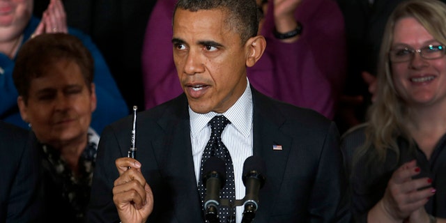 Nov. 9, 2012: President Barack Obama holds up a pen as he speaks about the economy and the deficit.