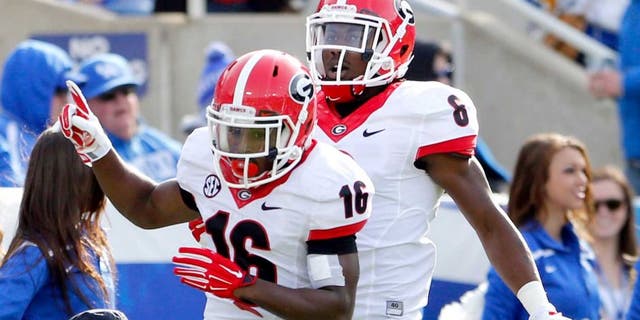 Nov 8, 2014; Lexington, KY, USA; Georgia Bulldogs wide receiver Isaiah McKenzie (16) and flanker Blake Tibbs (8) celebrate during the game against the Kentucky Wildcats at Commonwealth Stadium. Georgia defeated Kentucky 63-31. Mandatory Credit: Mark Zerof-USA TODAY Sports