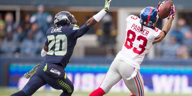 Nov 9, 2014; Seattle, WA, USA; New York Giants wide receiver Preston Parker (83) catches a pass over Seattle Seahawks cornerback Jeremy Lane (20) during the first half at CenturyLink Field. Seattle defeated New York 38-17. Mandatory Credit: Steven Bisig-USA TODAY Sports