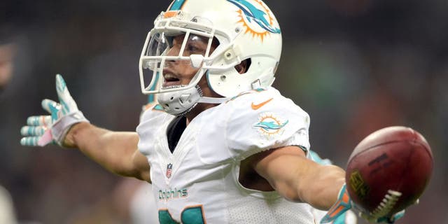 Sep 28, 2014; London, UNITED KINGDOM; Miami Dolphins cornerback Brent Grimes (21) celebrates after an interception against the Oakland Raiders in the NFL International Series game at Wembley Stadium. The Dolphins defeated the Raiders 38-14. Mandatory Credit: Kirby Lee-USA TODAY Sports
