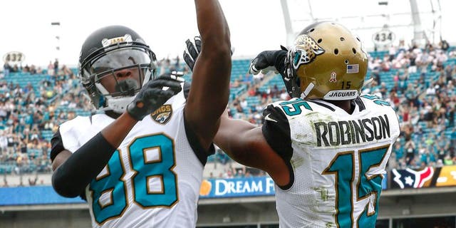 Oct 18, 2015; Jacksonville, FL, USA; Jacksonville Jaguars wide receiver Allen Robinson (15) and wide receiver Allen Hurns (88) celebrate a touchdown during the second half of a football game against the Houston Texans at EverBank Field. Mandatory Credit: Reinhold Matay-USA TODAY Sports