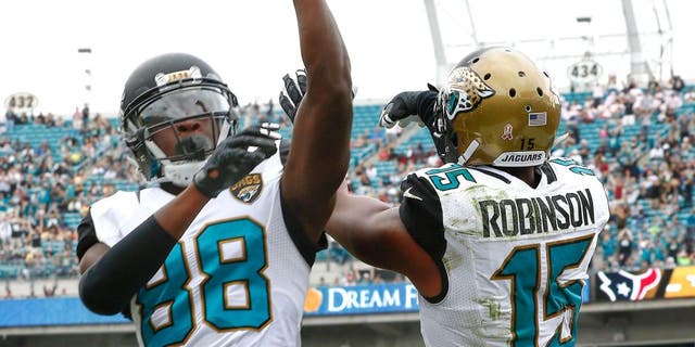 Oct 18, 2015; Jacksonville, FL, USA; Jacksonville Jaguars wide receiver Allen Robinson (15) and wide receiver Allen Hurns (88) celebrate a touchdown during the second half of a football game against the Houston Texans at EverBank Field. Mandatory Credit: Reinhold Matay-USA TODAY Sports