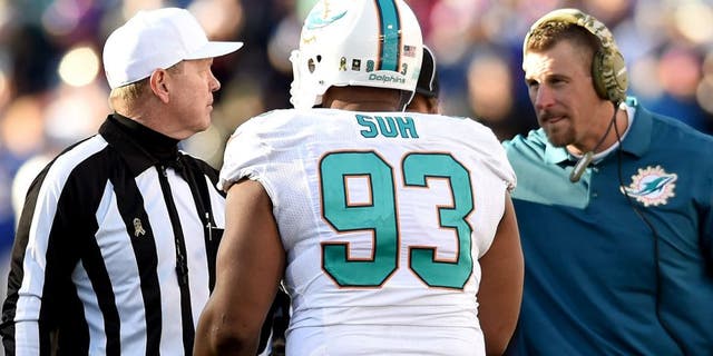ORCHARD PARK, NY - NOVEMBER 08: Ndamukong Suh #93 of the Miami Dolphins talks to referee Carl Cheffers #51 as Interm Head Coach Dan Campbell of the Miami Dolphins listens during the second half against the Buffalo Bills at Ralph Wilson Stadium on November 8, 2015 in Orchard Park, New York. (Photo by Rich Barnes/Getty Images)