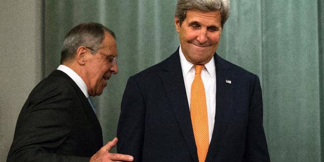 U.S. Secretary of State John Kerry, right, and Russian Foreign Minister Sergey Lavrov arrive to a news conference after their long talks in Moscow, Russia, Friday, July 15, 2016. The United States is offering Russia a broad new military partnership in Syria. (AP Photo/Alexander Zemlianichenko)