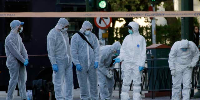 Nov. 10, 2016: Police search for evidence after an explosion outside the French Embassy in Athens.