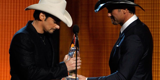 Nov. 10: Brad Paisley, left, accepts the Entertainer of the Year Award from Tim McGraw at the 44th Annual CMAs in Nashville.