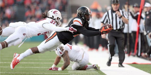 Nov 8, 2014; Corvallis, OR, USA; Washington State Cougars safety Sulaiman Hameed (37) tackles Oregon State Beavers wide receiver Hunter Jarmon (7) at Reser Stadium. Mandatory Credit: Scott Olmos-USA TODAY Sports