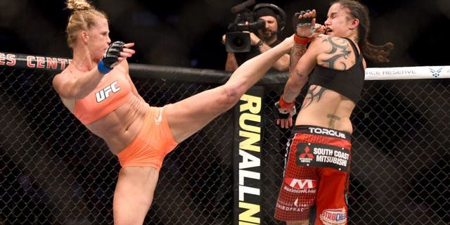 LOS ANGELES, CA - FEBRUARY 28: (L) Holly Holm kicks Raquel Pennington in their women's bantamweight bout during the UFC 184 event at Staples Center on February 28, 2015 in Los Angeles, California. (Photo by Jeff Bottari/Zuffa LLC/Zuffa LLC via Getty Images)
