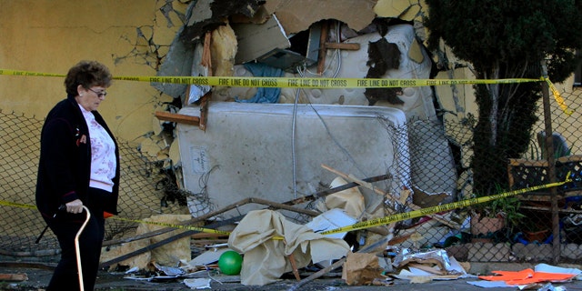 Nov. 1: A woman walks by a house that a pick up truck was driven into in Los Angeles.