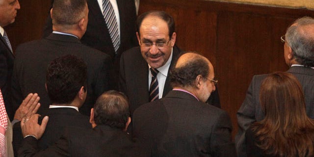 Nov. 11: Iraqi Prime Minister Nouri al-Malik, center, shakes hands with a lawmaker during a parliament session in Baghdad, Iraq.