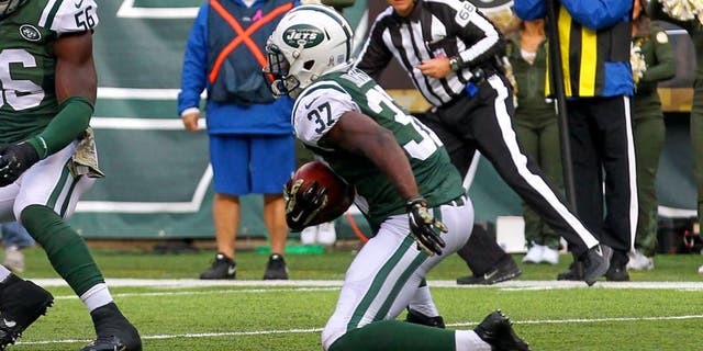 Nov 9, 2014; East Rutherford, NJ, USA; New York Jets free safety Jaiquawn Jarrett (37) returns an interception thrown by Pittsburgh Steelers quarterback Ben Roethlisberger (7) (not shown) during the first half at MetLife Stadium. Mandatory Credit: Ed Mulholland-USA TODAY Sports