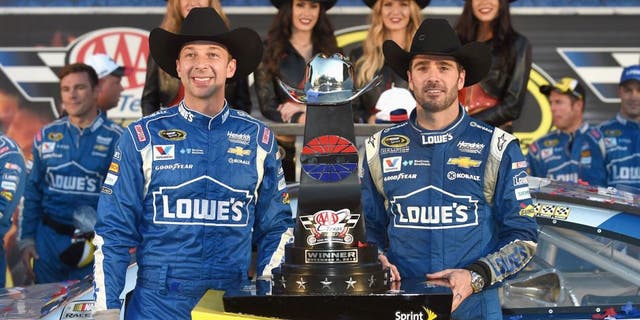 FORT WORTH, TX - NOVEMBER 08: Jimmie Johnson, driver of the #48 Lowe's Chevrolet, and crew chief Chad Knaus celebrate in victory lane with the trophy after winning the NASCAR Sprint Cup Series AAA Texas 500 at Texas Motor Speedway on November 8, 2015 in Fort Worth, Texas. (Photo by Rainier Ehrhardt/NASCAR via Getty Images)