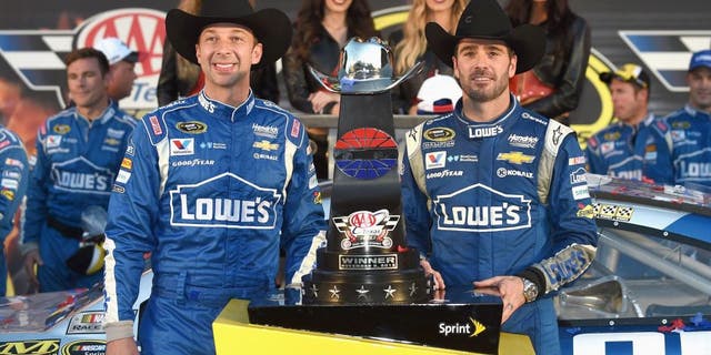 FORT WORTH, TX - NOVEMBER 08: Jimmie Johnson, driver of the #48 Lowe's Chevrolet, and crew chief Chad Knaus celebrate in victory lane with the trophy after winning the NASCAR Sprint Cup Series AAA Texas 500 at Texas Motor Speedway on November 8, 2015 in Fort Worth, Texas. (Photo by Rainier Ehrhardt/NASCAR via Getty Images)