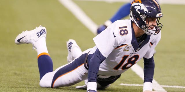 Nov 8, 2015; Indianapolis, IN, USA; Denver Broncos quarterback Peyton Manning (18) looks up while on the ground after throwing an interception against the Indianapolis Colts at Lucas Oil Stadium. Indianapolis defeats Denver 27-24. Mandatory Credit: Brian Spurlock-USA TODAY Sports