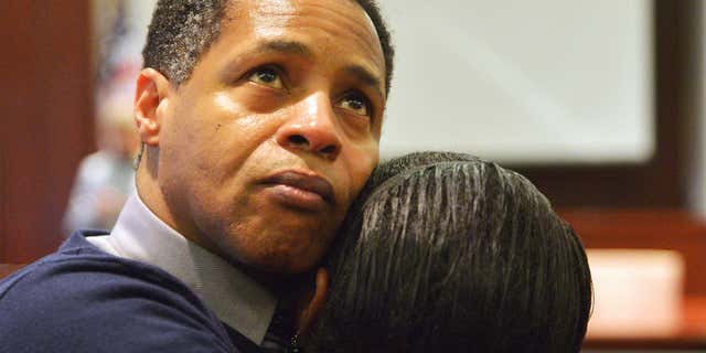 Dec. 5, 2013: Timothy Johnson embraces a family member after he was exonerated of a 1984 killing in Houston County in Perry, Ga.