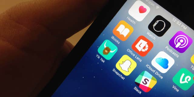 Nov. 11, 2015: The Yik Yak app, lower, left, is seen on an iPhone in Washington.
