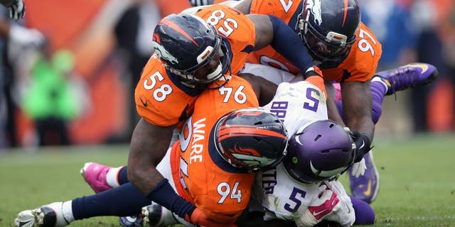 DENVER, CO - OCTOBER 04: Outside linebacker Von Miller #58, outside linebacker DeMarcus Ware #94 and defensive end Malik Jackson #97 of the Denver Broncos gang tackle quarterback Teddy Bridgewater #5 of the Minnesota Vikings at Sports Authority Field at Mile High on October 4, 2015 in Denver, Colorado. The Broncos defeated the Vikings 23-20. (Photo by Doug Pensinger/Getty Images)