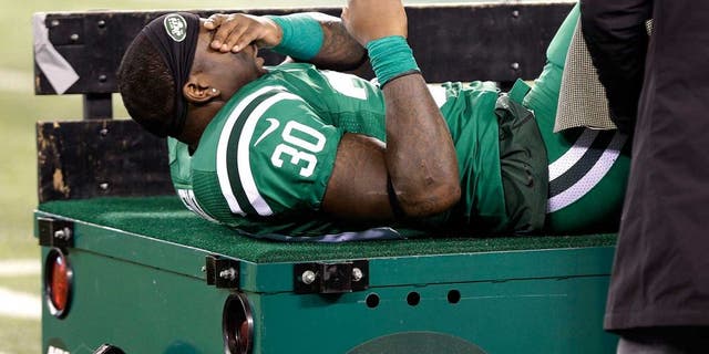 New York Jets running back Zac Stacy reacts as he is treated by trainers before being carted off the field during the first half of an NFL football game against the Buffalo Bills, Thursday, Nov. 12, 2015, in East Rutherford, N.J. (AP Photo/Seth Wenig)