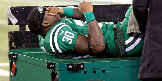 New York Jets running back Zac Stacy reacts as he is treated by trainers before being carted off the field during the first half of an NFL football game against the Buffalo Bills, Thursday, Nov. 12, 2015, in East Rutherford, N.J. (AP Photo/Seth Wenig)