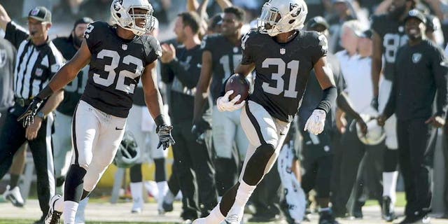 Sep 20, 2015; Oakland, CA, USA; Oakland Raiders cornerback Neiko Thorpe (31) celebrates with safety Keenan Lambert (32) after intercepting a pass in the final minute against the Baltimore Ravens as at O.co Coliseum. The Raiders defeated the Ravens 37-33. Mandatory Credit: Kirby Lee-USA TODAY Sports