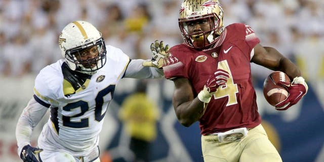 Oct 24, 2015; Atlanta, GA, USA; Florida State Seminoles running back Dalvin Cook (4) runs against Georgia Tech Yellow Jackets defensive back Lawrence Austin (20) in the second quarter of their game at Bobby Dodd Stadium. Mandatory Credit: Jason Getz-USA TODAY Sports