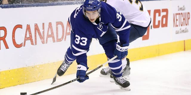Oct 27, 2016; Toronto, Ontario, CAN; Toronto Maple Leafs center Seth Griffith (33) is knocked off balance by Florida Panthers defenseman Keith Yandle (3) at Air Canada Centre. Mandatory Credit: Tom Szczerbowski-USA TODAY Sports