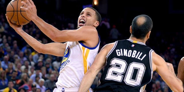 Nov 11, 2014; Oakland, CA, USA; Golden State Warriors guard Stephen Curry (30, left) shoots the ball against San Antonio Spurs guard Manu Ginobili (20) during the first quarter at Oracle Arena. Mandatory Credit: Kyle Terada-USA TODAY Sports