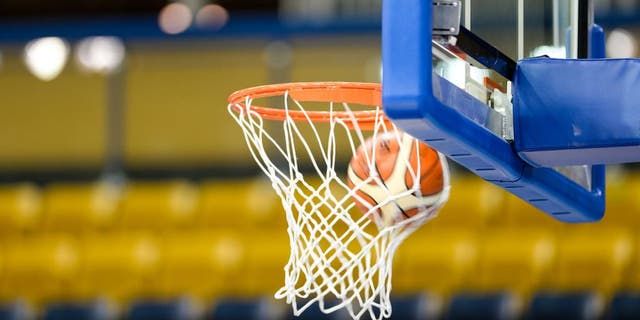RYERSON ATHLETIC CENTRE, TORONTO, ONTARIO, CANADA - 2015/07/16: Toronto 2015 Pan Am or Pan American Games, women basketball: A Molten ball entering the net or bucket in a basketball court with empty seats. (Photo by Roberto Machado Noa/LightRocket via Getty Images)