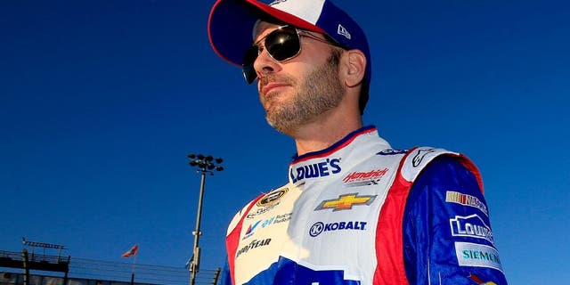 AVONDALE, AZ - NOVEMBER 13: Jimmie Johnson, driver of the #48 Lowe's Patriotic Chevrolet, walks on the grid during qualifying for the NASCAR Sprint Cup Series Quicken Loans Race for Heroes 500 at Phoenix International Raceway on November 13, 2015 in Avondale, Arizona. (Photo by Chris Trotman/Getty Images)