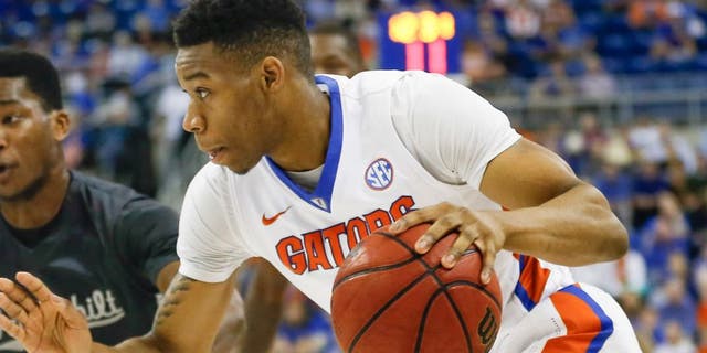 Feb 23, 2016; Gainesville, FL, USA; Florida Gators forward Justin Leon (24) drives past Vanderbilt Commodores center Damian Jones (30) during the first half of a basketball game at the Stephen C. O'Connell Center. Mandatory Credit: Reinhold Matay-USA TODAY Sports