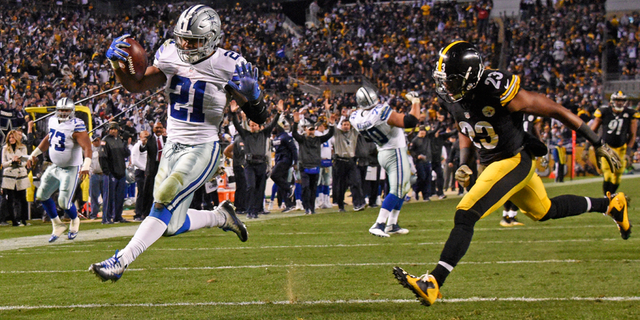 Dallas Cowboys running back Ezekiel Elliott (21) rushes for a touchdown with Pittsburgh Steelers free safety Mike Mitchell (23) defending during the second half of an NFL football game in Pittsburgh, Sunday, Nov. 13, 2016. (AP Photo/Don Wright)