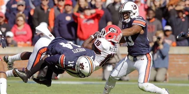 Nov 14, 2015; Auburn, AL, USA; Georgia Bulldogs receiver Isaiah McKenzie (16) is tackled by Auburn Tigers defensive backs Stephen Roberts (14) and Johnathan Ford (23) during the second quarter at Jordan Hare Stadium. Mandatory Credit: John Reed-USA TODAY Sports