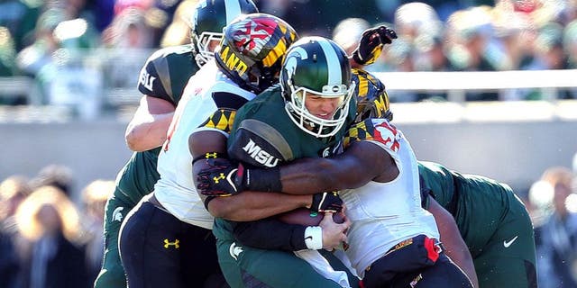 Nov 14, 2015; East Lansing, MI, USA; Michigan State Spartans quarterback Connor Cook (18) carries the ball against the Maryland Terrapins during the first half at Spartan Stadium. Mandatory Credit: Mike Carter-USA TODAY Sports