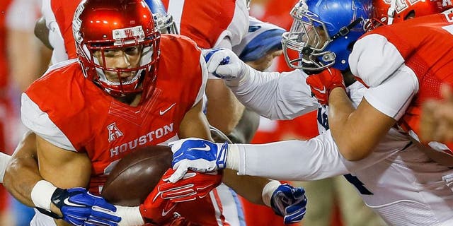 HOUSTON, TX - NOVEMBER 14: Kenneth Farrow #35 of the Houston Cougars is tackled by the Memphis Tigers in the second quarter on November 14, 2015 in Houston, Texas. (Photo by Bob Levey/Getty Images)