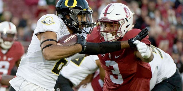 November 14, 2015; Stanford, CA, USA; Oregon Ducks wide receiver Charles Nelson (6) runs with the football against Stanford Cardinal linebacker Noor Davis (3) during the first quarter at Stanford Stadium. Mandatory Credit: Kyle Terada-USA TODAY Sports