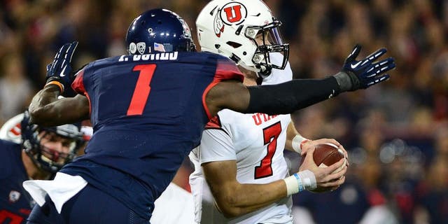 TUCSON, AZ - NOVEMBER 14: Quarterback Travis Wilson #7 of the Utah Utes is sacked by safety Tellas Jones #1 of the Arizona Wildcats in the first quarter of the game at Arizona Stadium on November 14, 2015 in Tucson, Arizona. (Photo by Jennifer Stewart/Getty Images)