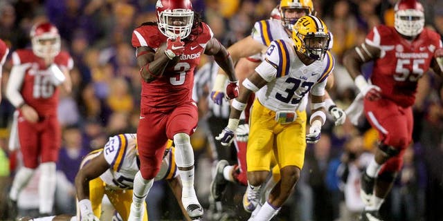 Nov 14, 2015; Baton Rouge, LA, USA; Arkansas Razorbacks running back Alex Collins (3) carries the ball to score a touchdown against the LSU Tigers in the first half at Tiger Stadium. Mandatory Credit: Crystal LoGiudice-USA TODAY Sports