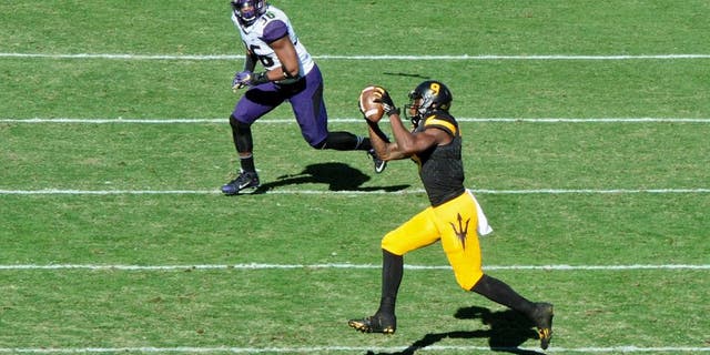 Nov 14, 2015; Tempe, AZ, USA; Arizona State Sun Devils running back Kalen Ballage (9) makes a catch as Washington Huskies linebacker Azeem Victor (36) defends during the first half at Sun Devil Stadium. Mandatory Credit: Matt Kartozian-USA TODAY Sports