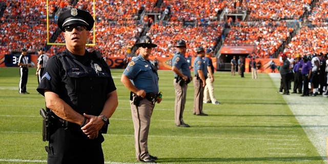 DENVER, CO - SEPTEMBER 13: Law enforcement officers provide security on the field during a break in the action between the Baltimore Ravens and the Denver Broncos at Sports Authority Field at Mile High on September 13, 2015 in Denver, Colorado. The Broncos defeated the Ravens 19-13. (Photo by Doug Pensinger/Getty Images)