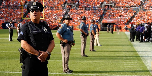 DENVER, CO - SEPTEMBER 13: Law enforcement officers provide security on the field during a break in the action between the Baltimore Ravens and the Denver Broncos at Sports Authority Field at Mile High on September 13, 2015 in Denver, Colorado. The Broncos defeated the Ravens 19-13. (Photo by Doug Pensinger/Getty Images)