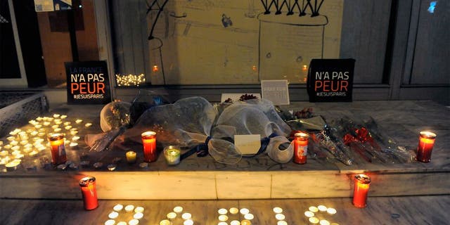 Flowers and candles reading "Paris" are pictured outside the French consulate in Thessaloniki on November 14, 2015, a day after deadly attacks in Paris. Islamic State jihadists claimed a series of coordinated attacks by gunmen and suicide bombers in Paris that killed at least 128 people in scenes of carnage at a concert hall, restaurants and the national stadium. The placards read "France is not afraid". AFP PHOTO / Sakis Mitrolidis (Photo credit should read SAKIS MITROLIDIS/AFP/Getty Images)