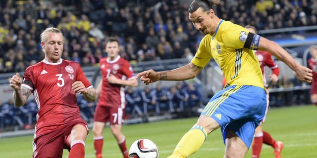 Denmark's defender Simon Kjaer (L) reacts as Sweden's forward and team captain Zlatan Ibrahimovic (r) shoots during the Euro 2016 play-off football match between Sweden and Denmark at the Friends arena in Solna on November 14, 2015. AFP PHOTO / JONATHAN NACKSTRAND (Photo credit should read JONATHAN NACKSTRAND/AFP/Getty Images)