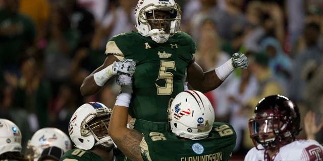 Nov 14, 2015; Tampa, FL, USA; South Florida Bulls running back Marlon Mack (5) celebrates with offensive lineman Dominique Threatt (61) and offensive lineman Brynjar Gudmundsson (66) after scoring a touchdown in the second quarter against the Temple Owls at Raymond James Stadium. Mandatory Credit: Logan Bowles-USA TODAY Sports