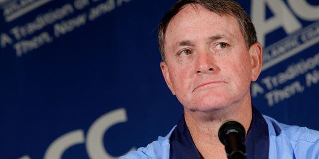 FILE - In this July 25, 2011 file photo, North Carolina coach Butch Davis pauses during interviews at the Atlantic Coast Conference Football Kickoff in Pinehurst, N.C. Davis was hired Monday, Nov. 14, 2016, as the new coach at FIU. (AP Photo/Gerry Broome, File)