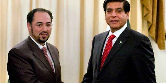 Nov. 12, 2012: Salahuddin Rabbani, left, head of Afghanistan High Peace Council, shakes hand with Pakistan's Prime Minister Raja Pervaiz Ashraf, for the benefit of the media prior to their meeting in Islamabad, Pakistan.
