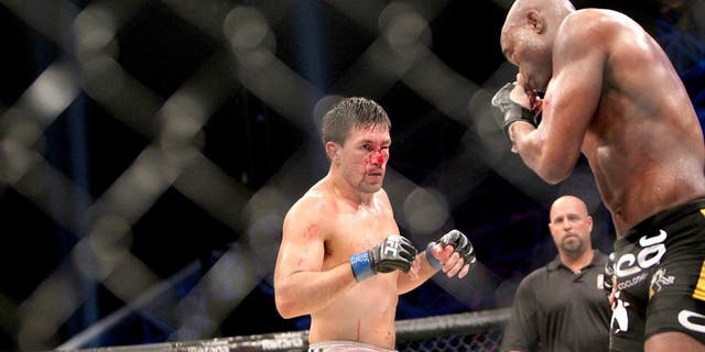 Brazil's Demian Maia (L) bleeds as his compatriot Anderson Silva prepares for an attack during their Ultimate Fighting Championship (UFC) 112 middleweight bout in Abu Dhabi on April 10, 2010. Silva won the fight. AFP PHOTO/KARIM SAHIB (Photo credit should read KARIM SAHIB/AFP/Getty Images)