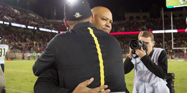 November 14, 2015; Stanford, CA, USA; Stanford Cardinal head coach David Shaw hugs Oregon Ducks head coach Mark Helfrich after the game at Stanford Stadium. The Ducks defeated the Cardinal 38-36. Mandatory Credit: Kyle Terada-USA TODAY Sports
