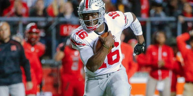 Oct 24, 2015; Piscataway, NJ, USA; Ohio State Buckeyes quarterback J.T. Barrett (16) turns up field during the first quarter against the Rutgers Scarlet Knights at High Points Solutions Stadium. Mandatory Credit: Jim O'Connor-USA TODAY Sports