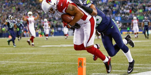 Nov 15, 2015; Seattle, WA, USA; Arizona Cardinals wide receiver Michael Floyd (15) catches a touchdown pass against Seattle Seahawks cornerback Cary Williams (26) during the second quarter at CenturyLink Field. Mandatory Credit: Joe Nicholson-USA TODAY Sports