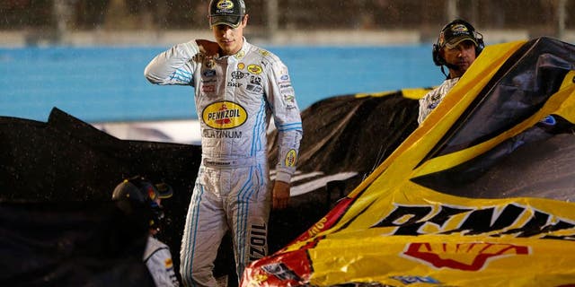 AVONDALE, AZ - NOVEMBER 15: Joey Logano, driver of the #22 Pennzoil Ford, stands on pit road during a red flag rain delay in the NASCAR Sprint Cup Series Quicken Loans Race for Heroes 500 at Phoenix International Raceway on November 15, 2015 in Avondale, Arizona. (Photo by Jonathan Ferrey/Getty Images)